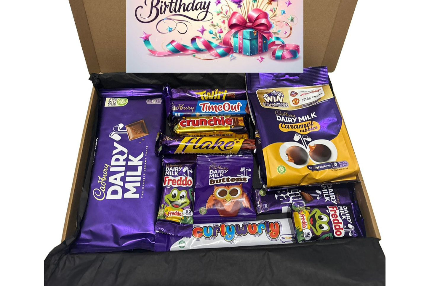 Open box of assorted candy bars with a 'Happy Birthday' card featuring balloons on a white background.